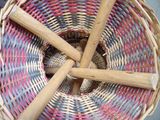 a wicker basket with four wooden sticks in it