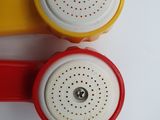 two red and yellow telephones sitting next to each other