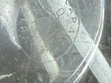 a close up of a glass container with a cigarette in it