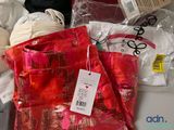 a red bag with a tag on it sitting on a table