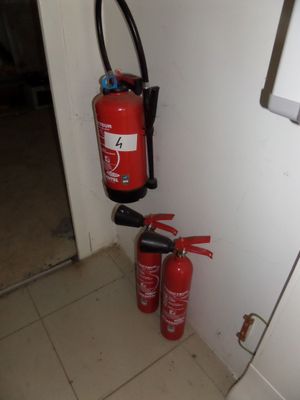 two fire extinguisors next to each other on the floor