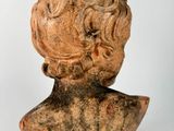 statue of a man ' s head with curly hair on a white background