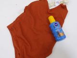 a bottle of sunscreen sitting on top of a underwear