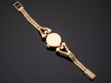 a gold watch on a black background