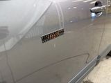 a close up of a car door with a sticker on it