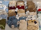 Plusieurs paires de vêtements pour hommes sont exposées sur une table.