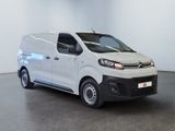 the white van is parked in a large room with a black floor