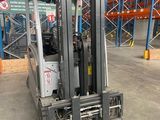 a forklift that is parked in a large warehouse