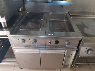 a large kitchen with a lot of stainless steel appliances