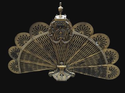 a gold fan that is on a black background