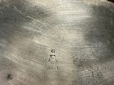 a silver plate that has a silver handle on it