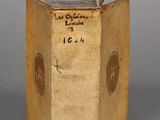 an old book sitting on top of a table on a gray surface