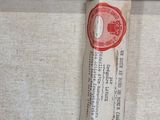 a piece of paper hanging on the wall next to a piece of wood