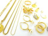 plusieurs types de bijoux en or et en argent disposés sur un fond blanc