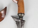 a knife and a wooden handle on a white surface