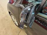 a close up of a car ' s side mirror with a sticker on it
