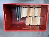 a red box with a bunch of books inside of it