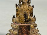 statue of a buddha sitting on a pedestal with a white background