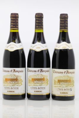 three bottles of wine sitting next to each other on a white surface