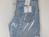 the back of a pair of jeans wrapped in plastic on a white surface