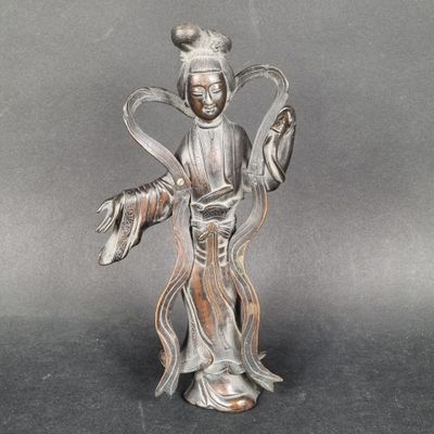 statue of a woman holding a fish in her right hand