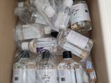 a cardboard box filled with bottles of alcohol and other items