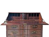 an old wooden desk with drawers and a mirror on top of it