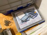 a box of screws and other tools on a table
