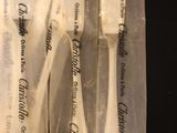 five plastic spoons in a clear bag on a table