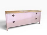 a pink chest of drawers with wooden top on a white background