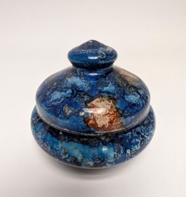 a blue and brown object on a white surface