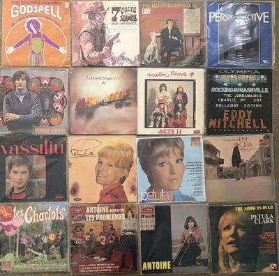 a lot of different vinyl records on the wall
