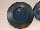 two blue and brown plates sitting on a table