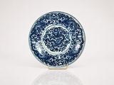 a blue and white plate with a dragon on it