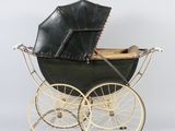 an old fashioned black and gold baby carriage with a black umbrella