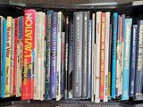 many books in a black box on the floor