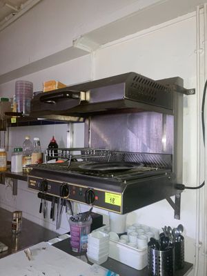 une cuisine équipée d'une cuisinière et d'un plan de travail sur lequel sont posés des plats