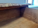 a close up of a wooden counter top with a window in the background