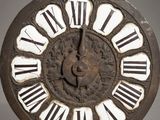 an old clock with roman numerals on the face of it