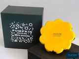 an image of a yellow soap sitting on top of a black box