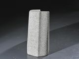 a concrete block sitting on the ground in the dark