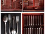 many different types of silverware in a wooden box