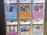 a lot of pokemon cards on display on a table