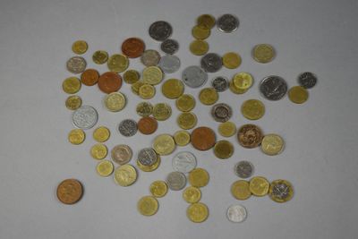 a pile of coins on a table with a white background