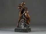 bronze statue of a woman hugging a dog on a marble base