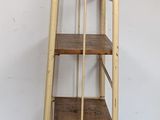 an image of a ladder shelf with a wooden shelf on top of it