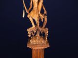 a statue of a man holding a fish on a pedestal