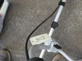 a person standing next to a scooter with a sticker attached to it