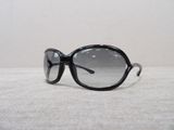 sunglasses on a table with a white wall in the background