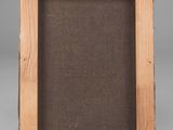 an old wooden picture frame with a brown linen backing